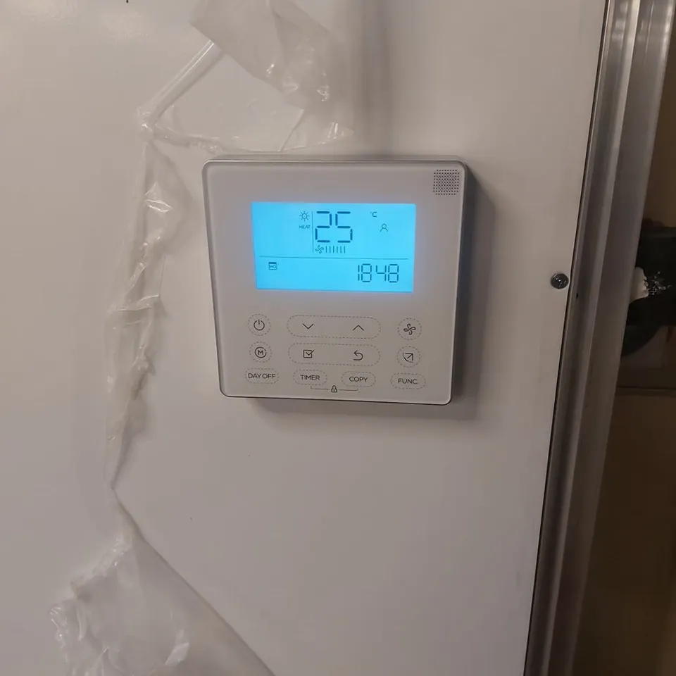 a thermostaer with a blue display on it