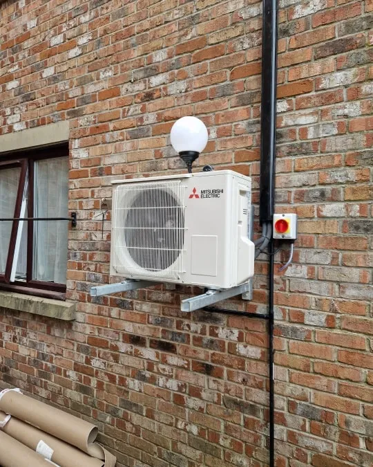 a air conditioner mounted to a brick wall