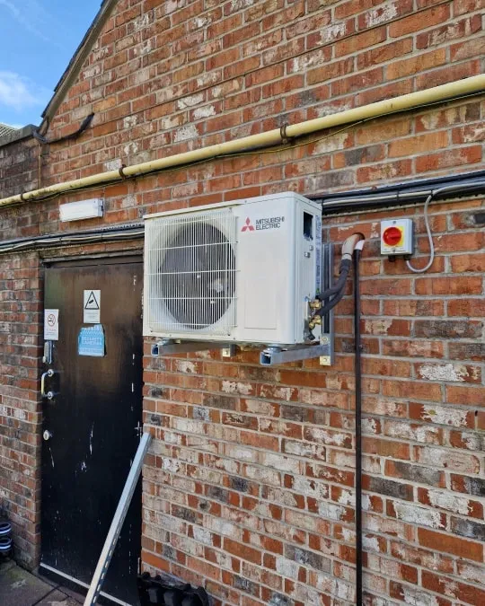 a brick building with a air conditioner attached to it