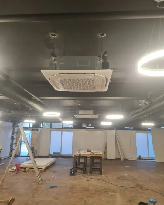 a large room with a ceiling fan and lights